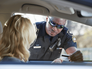 Police officer examining driver’s license during a traffic stop