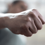 Close-up of a clenched fist suggesting aggressive intent